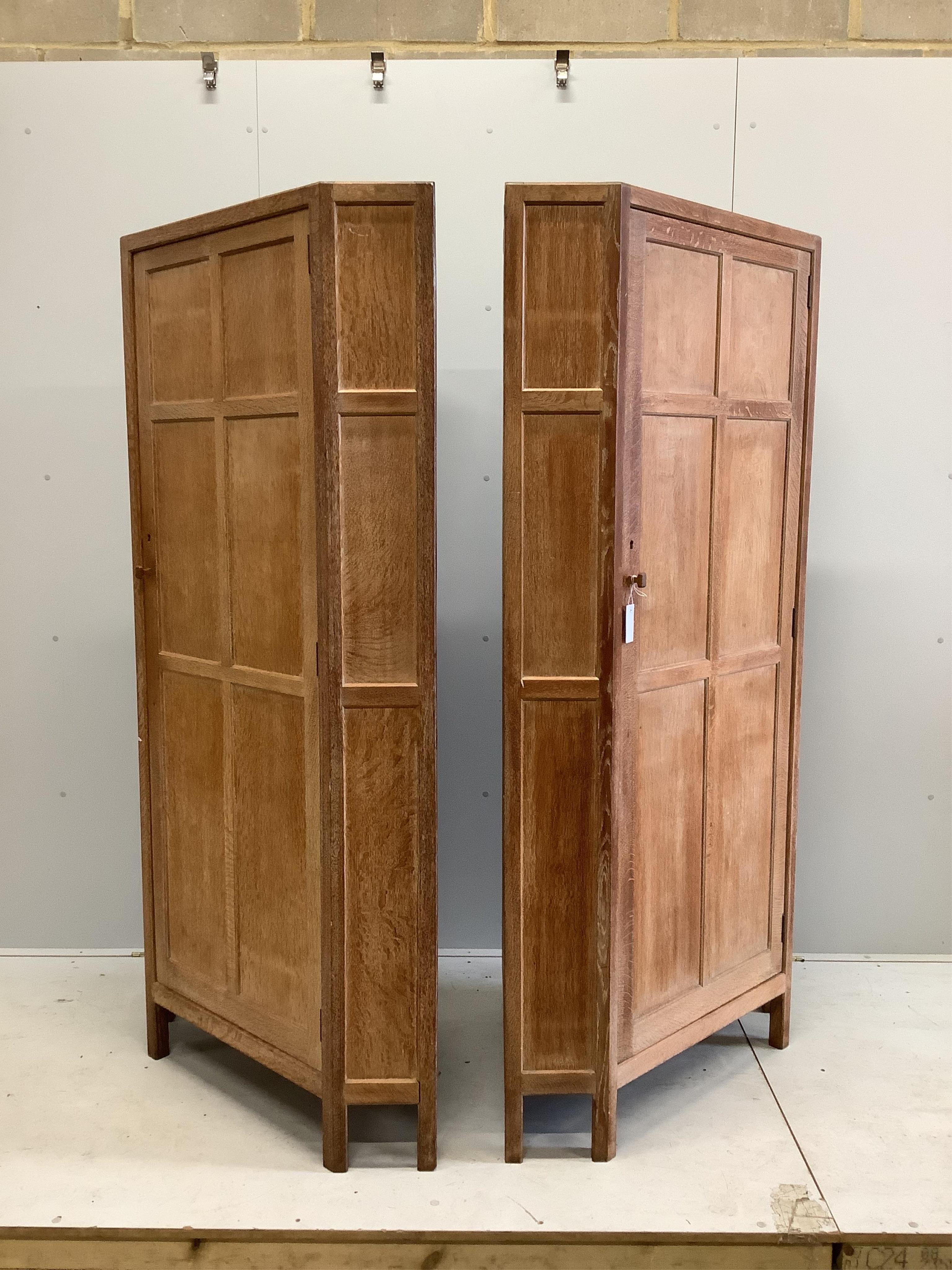 Heal & Son Ltd. A pair of weathered oak corner wardrobes, width 94cm, depth 53cm, height 182cm. Condition - fair to good